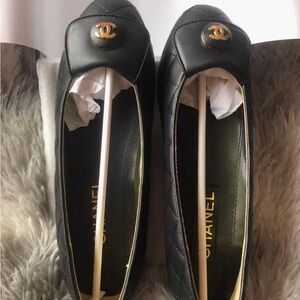 CHANEL Black Flats with Gold Logo